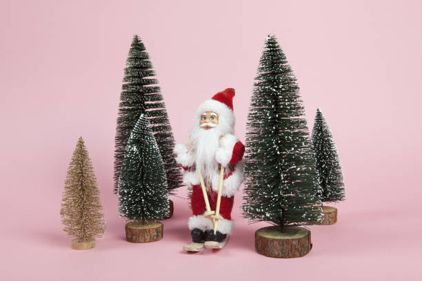 istock Santa Claus skiing on a pink background 1084903622