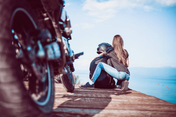 istock Motorcyclist Couple Enjoying Lake View 1084912256