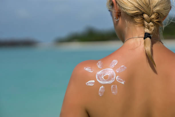 istock Woman with sun-shaped sun cream 1084912624
