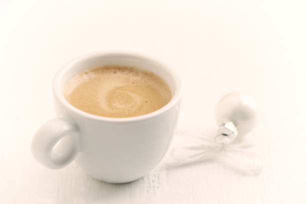 istock Small, white Christmas bauble and a cup of coffee. 1084920920