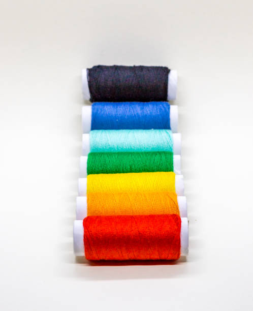 istock A sequence of red, orange, yellow, green and blue threads winded on reel 1084924272
