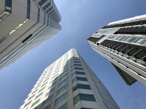 istock 3 Building and blue sky, view from bottom up to sky 1084925348