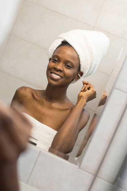 istock Young woman cleaning her ears 1084925674