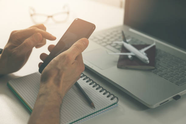 istock travel planning - using smart phone for online flight ticket and hotel booking 1084928710