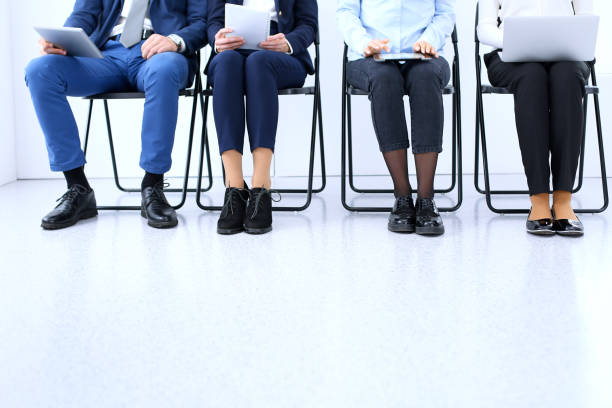 istock Group of business people sitting in office and waiting for job interview while using gadgets, close-up. Conference or training concepts 1084931108