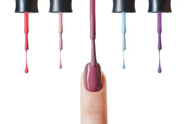 pastel nail polish on fingernail with wet brush isolated on white