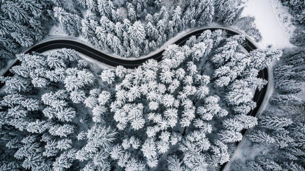 istock Heart shaped road in snowy forest, winter from above 1084949748