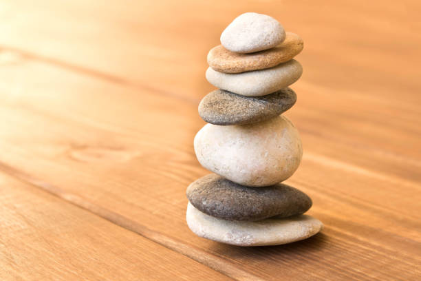 istock Balance the stones on the wooden table. 1084962702