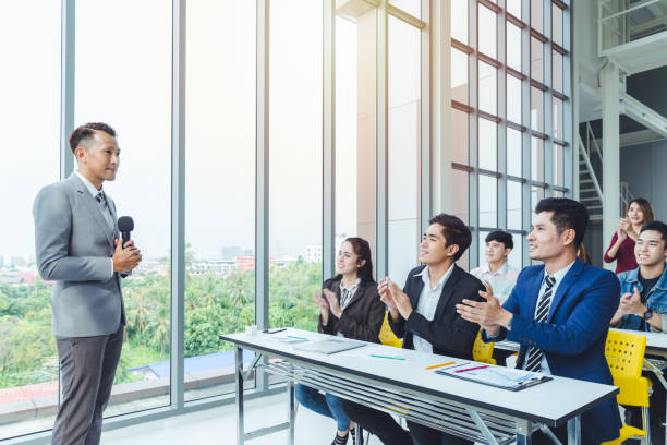 istock Asian Business men trainer giving presentation at conference 1084963368