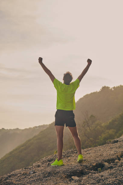 istock Man celebrating success after good training / exercise on a sandy ocean beach. 1084964694