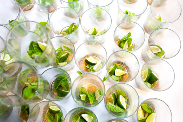 Mojito empty glasses with green leaves, sugar and lime. Wedding catering drinks concept