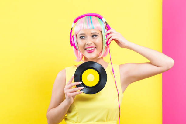 istock Woman in a wig holding a vinyl record 1084968068