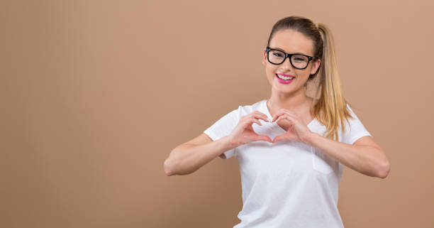 istock Woman making a heart shaped gesture 1084968102