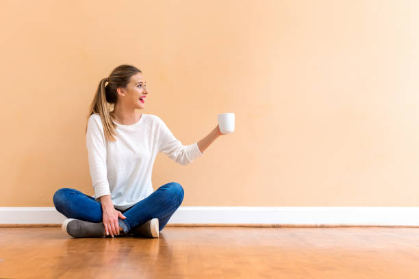 istock Young woman drinking a cup of coffee 1084968246