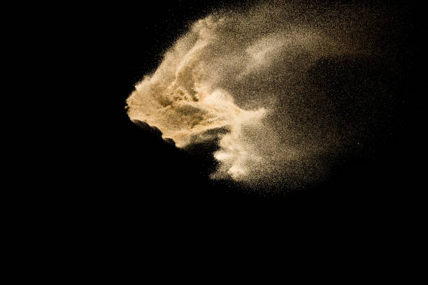 istock Golden sand explosion isolated on black background. Abstract sand cloud. 1084970610