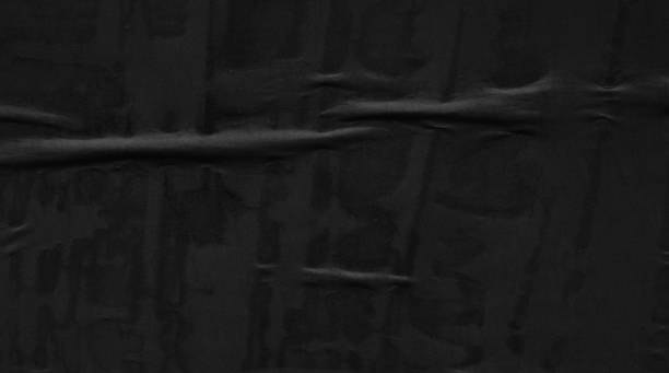 istock Dark black blank paper backgrounds creased crumpled surface old torn ripped posters grunge textures placard 1084973426