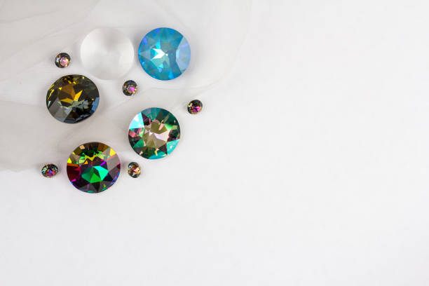 Gemstones crystals for jewelry scattered on white background