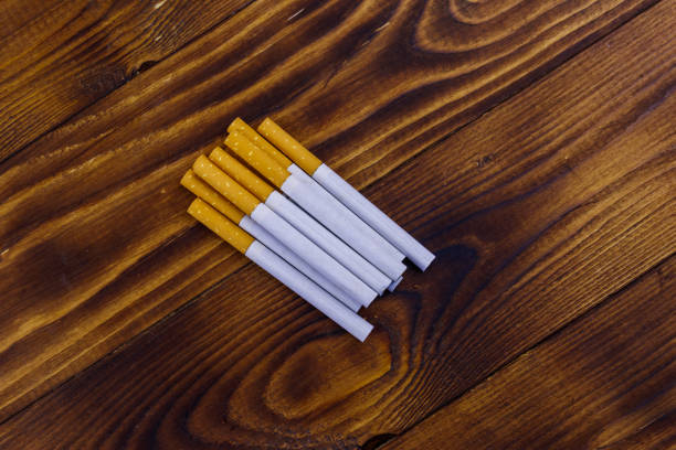 istock Tobacco cigarettes on wooden table 1084974848