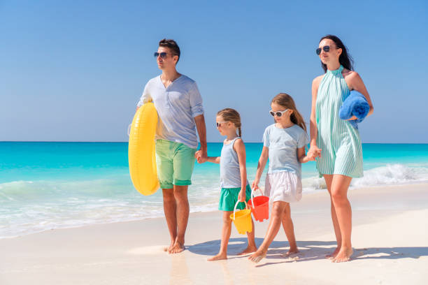 istock Young family on vacation have fun on the beach 1084978554