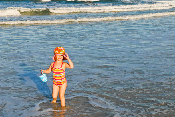 Young Girl Plays in the Ocean stock photo