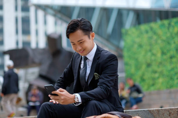 istock Young businessman using his smartphone on the street 1084981670