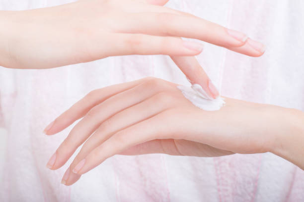 istock Woman putting hand cream on her hands 1084981826