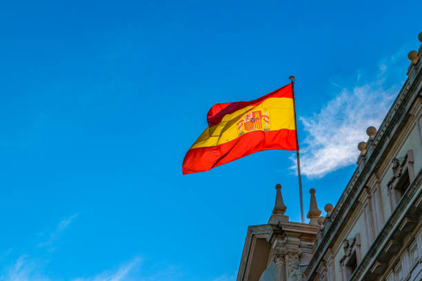 istock Spain Flag Waving at Top of Building 1084981944