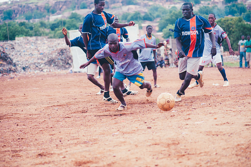 Mali, Africa - Black african children playing soccer in a rubbish dump. Rural area near Bamako