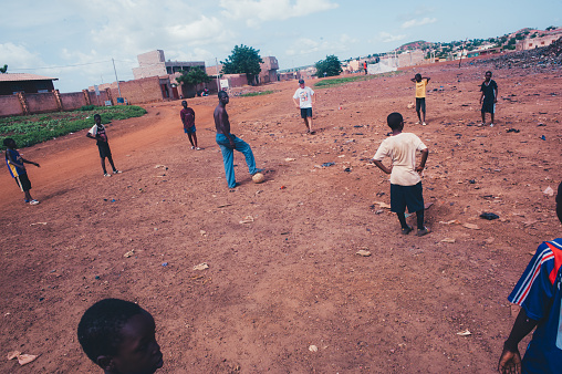 Mali, Africa - Black african children playing soccer in a rubbish dump. Rural area near Bamako