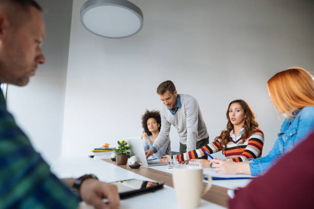 istock Multi racial group in business meeting, businessman explaining 1084989468