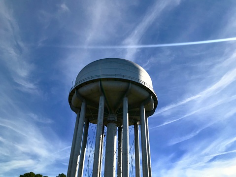 Small town water tower under blue sky