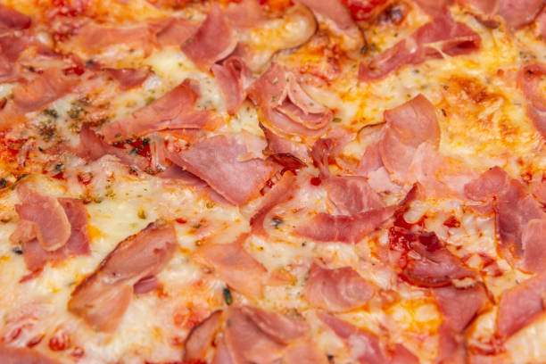 Photograph of a cheese and ham pizza