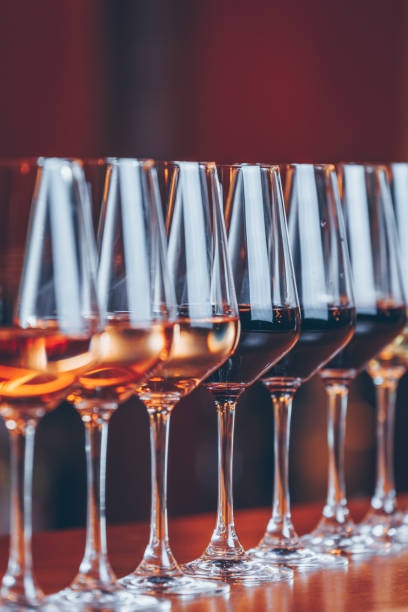 wine glasses in a row. buffet table celebration of wine tasting. nightlife, celebration and entertainment concept - coral break imagens e fotografias de stock