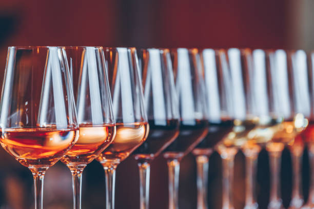 wine glasses in a row. buffet table celebration of wine tasting. nightlife, celebration and entertainment concept - coral break imagens e fotografias de stock