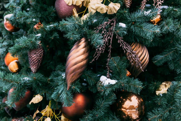 istock Christmas tree closeup. Golden balls and illuminated garland with flashlights. 1084998932