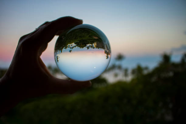 Sunset over Ocean with Full Moon in Glass Ball stock photo