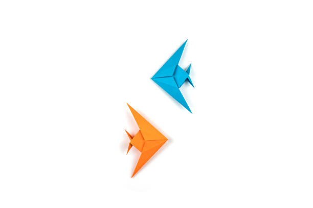 istock Two origami fishes isolated on white background. 1085000242