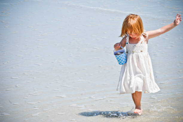 A young girl at the beach stock photo