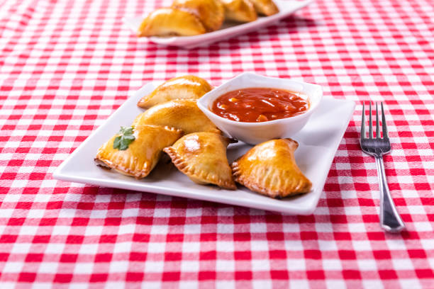 Empanada - a dish of South American cuisine - baked dumplings stuffed with meat and vegetable