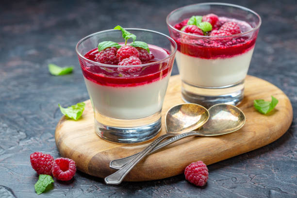 istock Vanilla Panna cotta with berry sauce and fresh raspberries. 1085005516