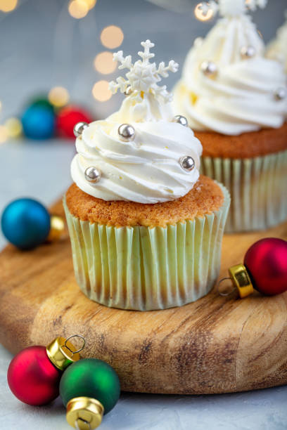 istock Cupcakes with vanilla cream and snowflakes. 1085006124
