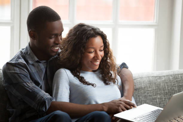 istock Loving African American couple using laptop together 1085009322
