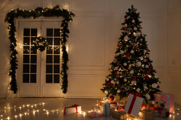 istock Christmas tree with presents, Garland lights new year holiday decor 1085011738