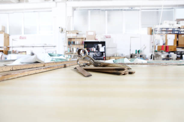 istock tailor's tools, old scissors, wooden meter and ruler on the sartorial work table 1085014194