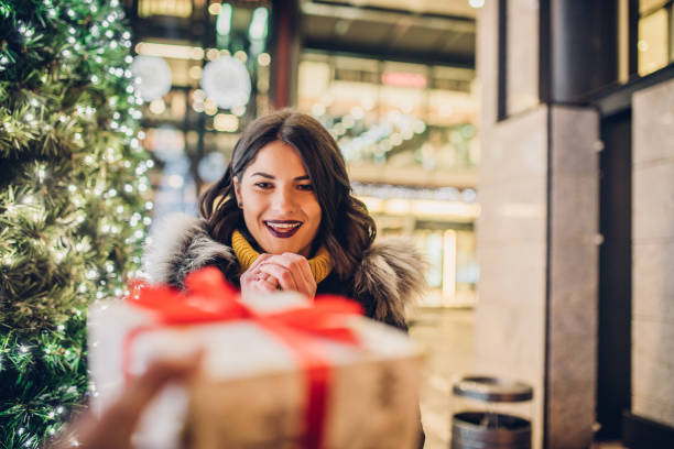 istock Girl smiling and looking at a present 1085017048