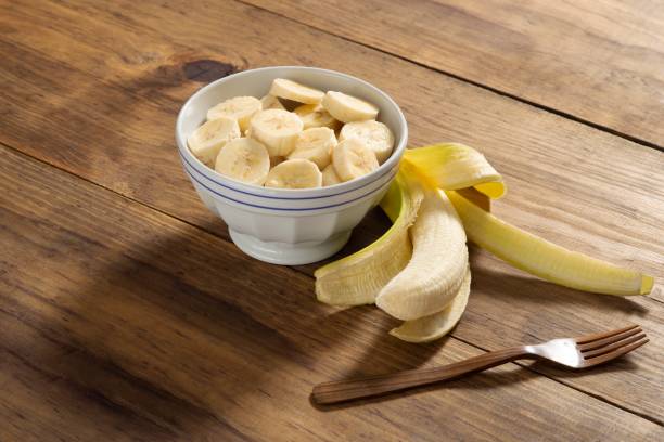 istock Banana slice on a bowl in a rustic pine wood table 1085018570