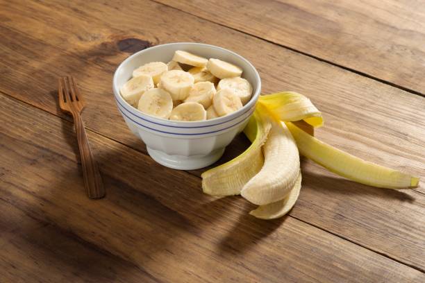 istock Banana slice on a bowl in a rustic pine wood table 1085018576
