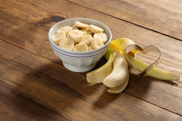 istock Banana slice on a bowl in a rustic pine wood table 1085018578
