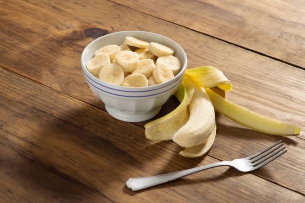 istock Banana slice on a bowl in a rustic pine wood table 1085018580