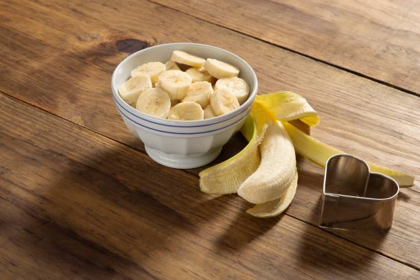 istock Banana slice on a bowl in a rustic pine wood table 1085018586